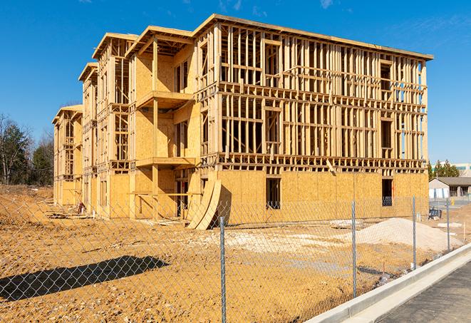 a tall, temporary chain link fence installed to protect a building site from unauthorized entry in Kiowa